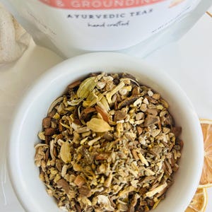 Close up of loose leaf herbal tea blend with dried botanicals in bowl, aromatic calming tea for relaxing evening routine and cozy tea moments