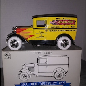 May include: A yellow and black die-cast model of a Hot Rod Delivery Van. The van features the text "The Hog Farm" and "25th Anniversary" on the side. The model has white-walled tires and is sitting on a box with a line drawing of the van.