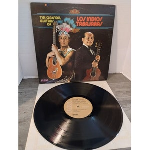 May include: A vinyl record album cover featuring two men playing classical guitars. The album is titled "The Classical Guitars of Los Indios Tabajaras" and is on the RCA Victor label.