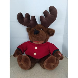 Singing Christmas Moose Plush Toy In Red Jacket With Brown Antlers