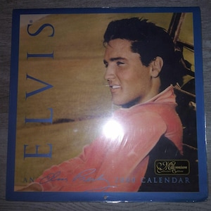 May include: A vintage-style calendar featuring a color photo of Elvis Presley. The calendar is titled "Elvis: An Elvis Presley 2000 Calendar" and has a Millennium Collector's Edition logo.