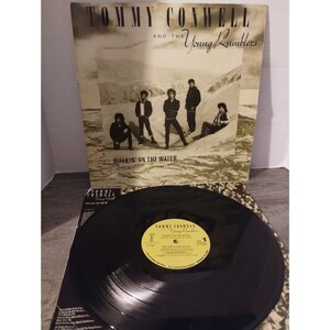 May include: Vinyl record album cover featuring a black and white photo of a band, Tommy Conwell and the Young Ramblers, with the album title "Walkin' on the Water".