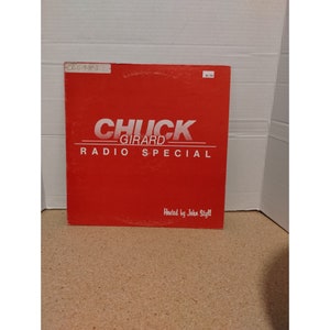 May include: Red vinyl record album cover with white text that reads "Chuck Girard Radio Special" and "Hosted by John Styll".