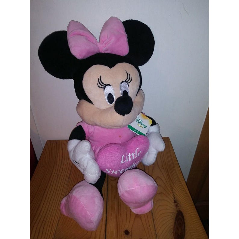 May include: Pink Minnie Mouse plush toy with a pink bow and a heart that says "Little Sweetheart".