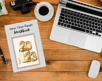 May include: A gray and brown workbook with the title "New Year Reset Workbook" and a gold 2023 graphic.