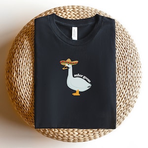 May include: Black t-shirt featuring a white goose wearing a sombrero and the text "se&ntilde;or goose".