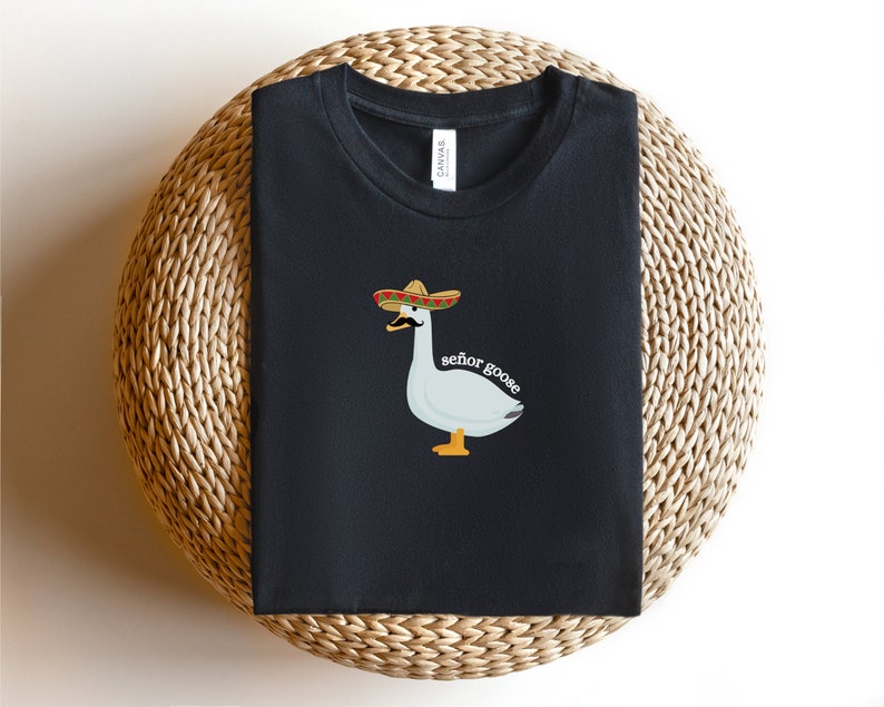May include: Black t-shirt featuring a white goose wearing a sombrero and the text "se&ntilde;or goose".