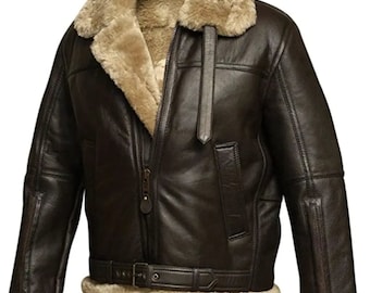 May include: A brown leather jacket with a shearling collar and lining. The jacket features a zip closure, a belt at the waist, and shearling trim on the cuffs and hem. The jacket has a classic aviator style.