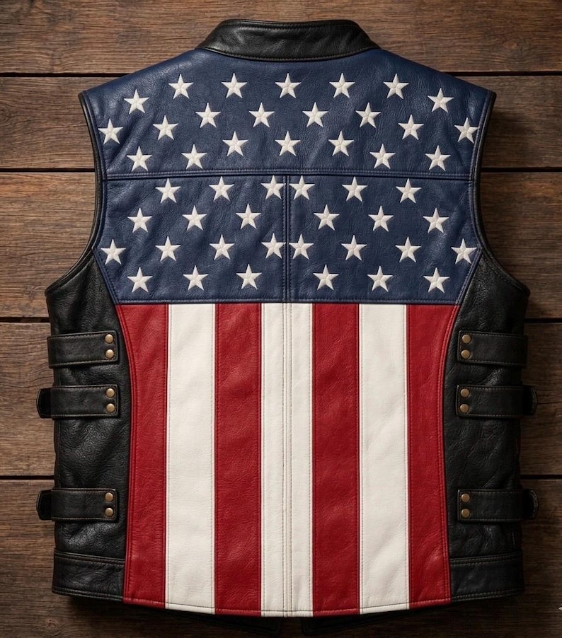 May include: Leather vest with a patriotic design. The back features a blue panel with white stars, red and white stripes, and black leather sides with adjustable straps. The vest is designed to be worn as outerwear.