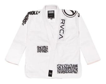 May include: White martial arts uniform with black graphic text and logos. The uniform features the brand name "RVCA" on the lapel and "SHOW ROLL" on the shoulder. Additional graphic text is on the chest and lower front.