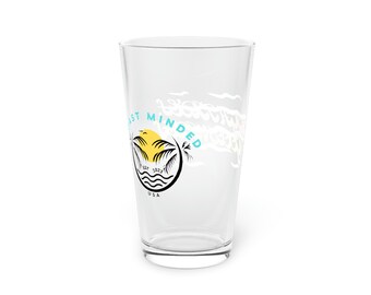 May include: A clear glass pint glass with a white graphic of a palm tree and sun with the text "Coast Minded Est. 2023 USA" printed on the side.