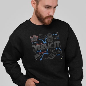 May include: A black sweatshirt featuring a graphic design of a computer network diagram. The design includes the word "YBRUCIT" and arrows pointing to different parts of the network. The design is in a white, grey, and blue colour scheme.