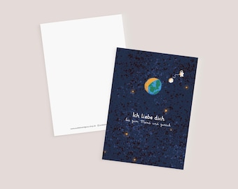 May include: A blue postcard with a dark blue background and white stars. The text "Ich liebe dich bis zum Mond und zurück" is written in white. A small astronaut is holding a rope attached to a small planet.