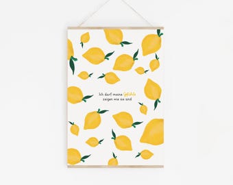 May include: A framed print featuring a pattern of yellow lemons with green leaves on a white background. The print includes the German text "Ich darf meine Gefühle zeigen wie sie sind."