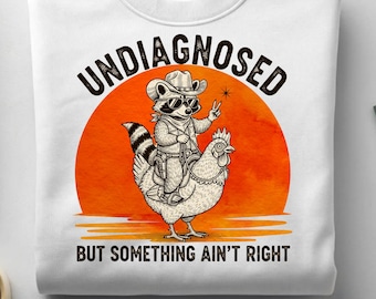 Undiagnosed But Something Ain't Right Raccoon PNG, Raccoon Riding Chicken, Cowboy Animal Humor, Funny Sublimation Design, Quirky Farm Art