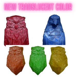 May include: Image of translucent owl and bird sculptures in red, blue, orange, green, and yellow. The sculptures have a geometric design and the text "NEW TRANSLUCENT COLOR" is displayed above the sculptures.