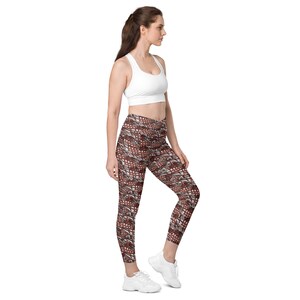 May include: A woman wearing a white sports bra and brown and white patterned leggings. The leggings have a geometric design.