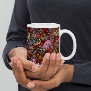 May include: White ceramic mug with a colorful design featuring various sea creatures, including a pink octopus, a jellyfish, and a seahorse.