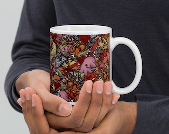 May include: White ceramic mug with a colorful design featuring various sea creatures, including a pink octopus, a jellyfish, and a seahorse.