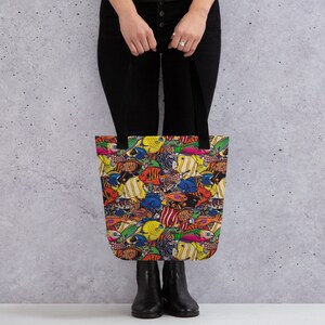 May include: A black tote bag with a colorful print of various fish. The fish are in shades of yellow, orange, red, blue, green, and purple.