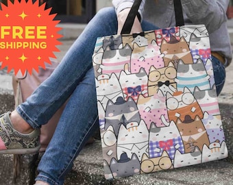 May include: A tote bag with a colorful pattern of cartoon cats wearing different outfits. The bag has a white background and features cats in various poses, including sitting, standing, and lying down. The cats are wearing hats, glasses, and bow ties.