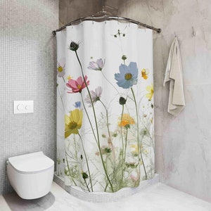 May include: White shower curtain with a floral print featuring pink, yellow, blue, and white flowers. The flowers are on a white background with green stems and leaves.