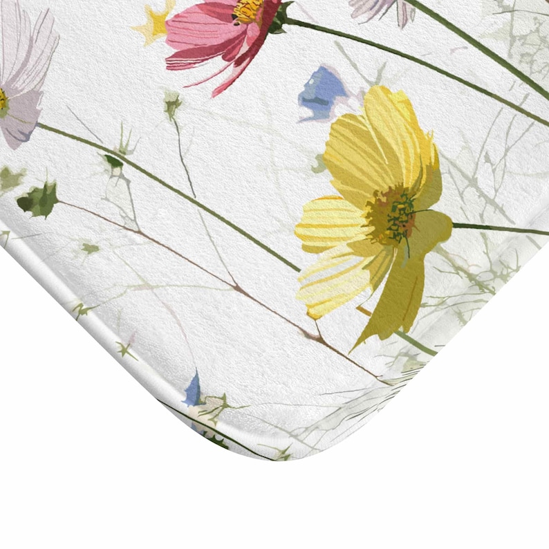 May include: A white background with a floral pattern featuring pink, yellow, and blue flowers with green stems.