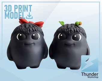 May include: Two black 3D printed figurines with large eyes and a smiling expression. The figurine on the left has a red bow on its head and the figurine on the right has green leaves and brown berries on its head.  3D Print Model Download.