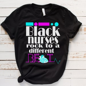 May include: Black t-shirt with the text "Black nurses rock to a different beat" in white with a pink heart and EKG line graphic.