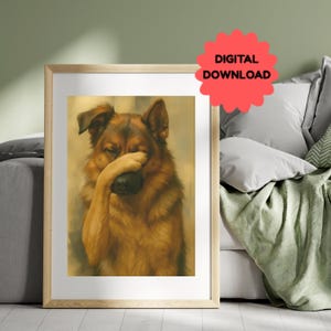 May include: A framed print featuring a German Shepherd dog covering its face with its paw. The dog has brown and black fur. The print is in a light wooden frame. A red sticker with the words "DIGITAL DOWNLOAD" is in the upper right corner.