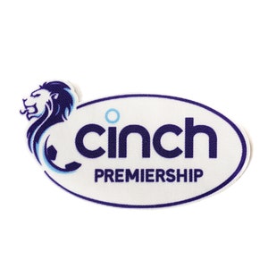 May include: A white oval patch with a blue outline. The patch has a blue lion logo on the left and the text "cinch PREMIERSHIP" in blue letters.