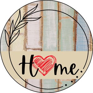 May include: Round wooden sign with a distressed, painted wood background. The sign has a black wreath with a leafy branch design. The words "Home" are written in black with a red heart in the middle.