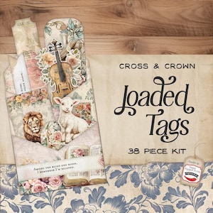 May include: A 38-piece kit of vintage-style paper tags with a cross and crown theme. The tags feature a variety of designs, including a lamb, a lion, a violin, and a book. The tags are printed on a textured paper with a distressed look. The text on the tags reads "Cross & Crown Loaded Tags 38 Piece Kit" and "Among the ruins and roses, I remember I'm beloved."