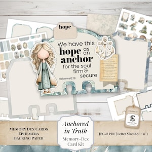 May include: A Memory Dex card kit with a watercolor design. The kit includes cards, ephemera, and backing paper. The design features an illustration of a girl, an anchor, and the text "We have this hope as an anchor for the soul firm & secure."