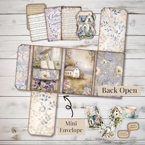 May include: A collection of paper ephemera with a vintage aesthetic. Includes a mini envelope, tags, and a multi-panel piece with floral and church illustrations. The color palette features soft blues, purples, and creams, with text that reads "Clothed in Compassion" and "Back Open".