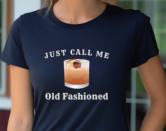 May include: A navy blue t-shirt with a white graphic of an old fashioned cocktail and the text "Just Call Me Old Fashioned".