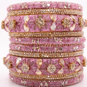 May include: A white ceramic mug with a black handle and the text "But First, Coffee" in a black, handwritten-style font. The mug is on a white surface.