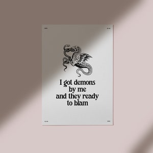 May include: Black and white illustration of a dragon with the text "I got demons by me and they ready to blame".