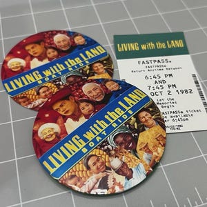 May include: Two round buttons and a Fastpass ticket. The buttons feature a collage of people and the text "LIVING with the LAND BOAT RIDE". The Fastpass ticket is dated October 2, 1982, with times 6:45 PM and 7:45 PM.