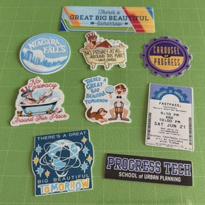 May include: A collection of colorful stickers with various designs and text. Designs include Niagara Falls, a man in a bathtub, a carousel, and the phrases "There's a Great Big Beautiful Tomorrow" and "Progress Tech School of Urban Planning."