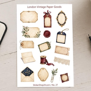 Könnte beinhalten: Ein Stickerbogen mit dem Titel London Vintage Paper Goods mit verschiedenen Illustrationen, darunter verzierte Rahmen, Geschenkanhänger, ein Wachssiegel, eine Garnrolle mit rotem Faden, eine Spitzenborte, ein offener Umschlag und eine Büroklammer.