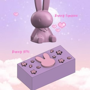 Könnte beinhalten: Eine rosa Hasenfigur und eine rosa rechteckige Box mit einem Hasenausschnitt und rosa Blumendesigns. Die Box trägt den Text "Bunny GPU" und "© Kitsune Kingdom".