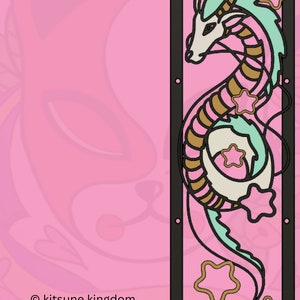 May include: A teal and gold dragon with pink flowers and stars, curled up in a decorative frame. The background is a pink gradient with a floral pattern. The text "&copy; kitsune kingdom" is at the bottom of the image.