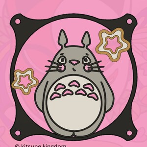 May include: A gray cartoon character with large ears and a fluffy body, surrounded by pink stars on a pink background. The character is inside a black frame with a white outline. The text "&copy; kitsune kingdom" is at the bottom of the image.