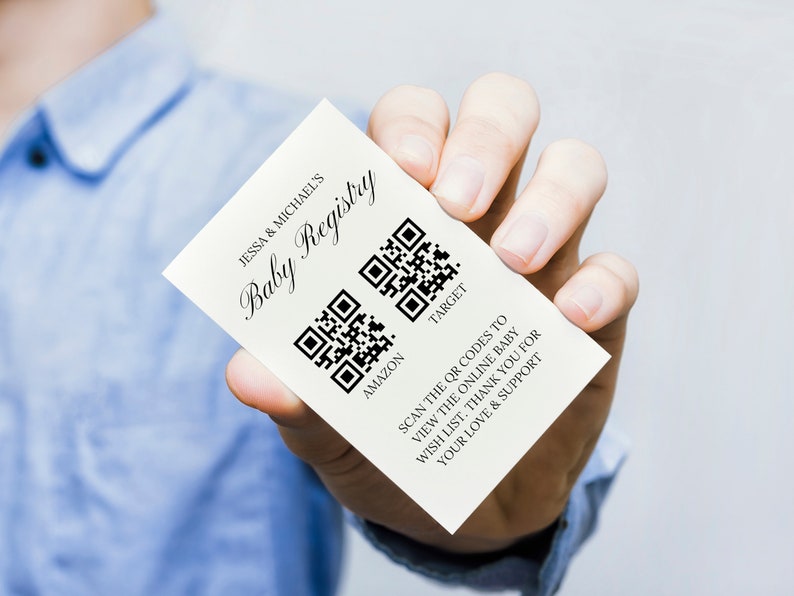May include: White card with the text "Jessa & Michael's Baby Registry" and two QR codes labeled "Amazon" and "Target". The text below the QR codes reads "Scan the QR codes to view the online baby wish list. Thank you for your love & support."