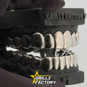 Top and bottom silver grillz display showing mirror finish shine.