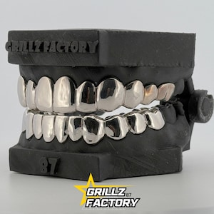 High polish silver teeth caps on black dental cast by Grillz Factory.