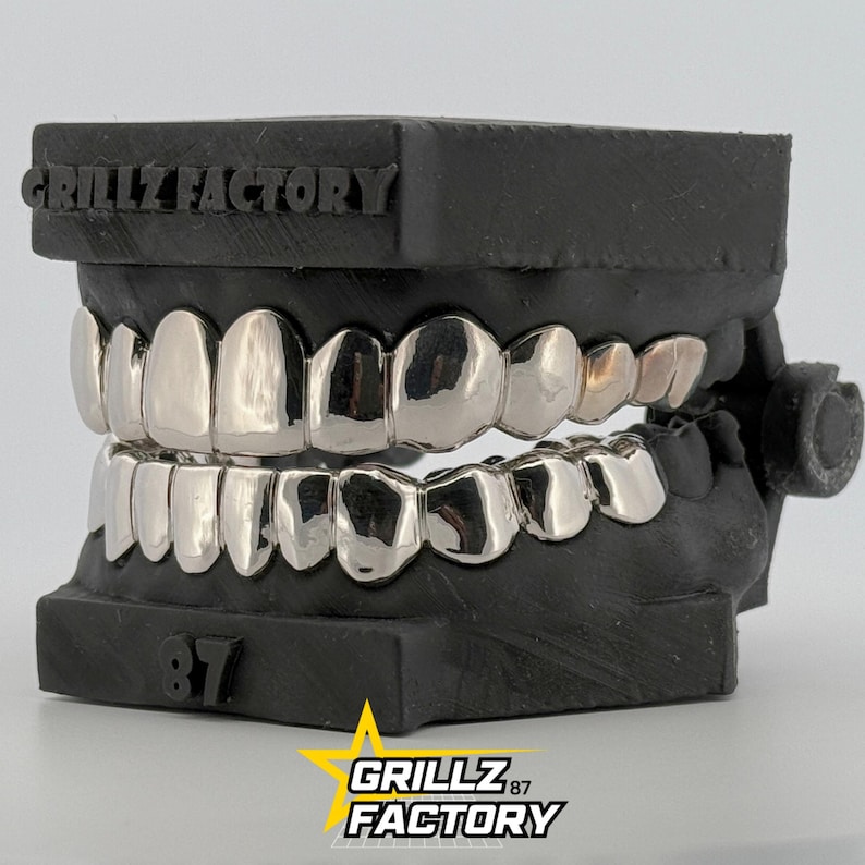 High polish silver teeth caps on black dental cast by Grillz Factory.