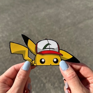 May include: A yellow cartoon character with a red and white baseball cap peeking out from behind a surface. The character has black eyes and a black nose.