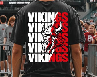 May include: A black short-sleeve t-shirt featuring a graphic on the back with the word VIKINGS repeated five times in white and red text. A detailed illustration of a Viking warrior with a horned helmet and beard is integrated into the design.